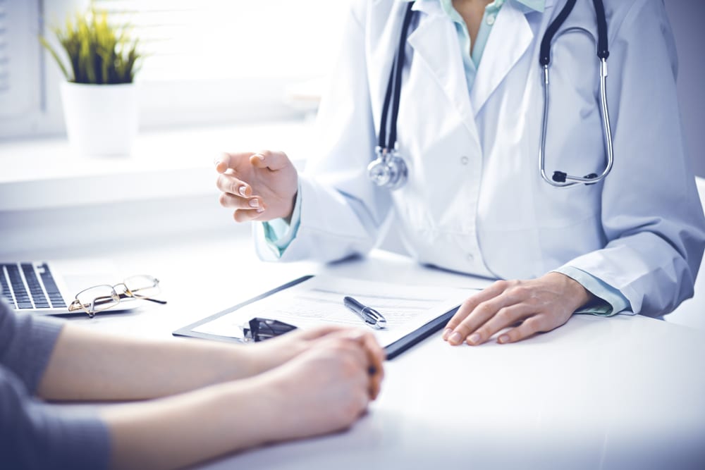 A bariatric surgeon assessing a patient to determine whether they qualify for gastric sleeve surgery.