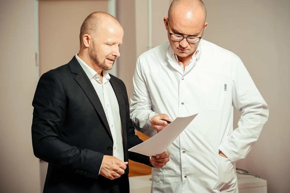 A clinician and a patient reviewing a document together.